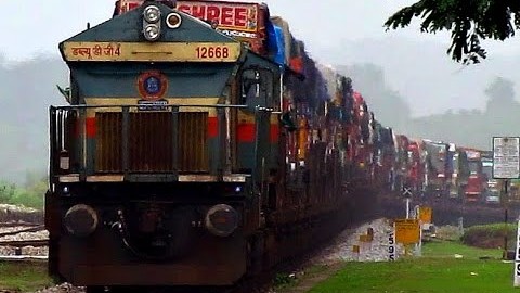 Trucks Lining Up To Take The Train! | Train Fanatics Videos