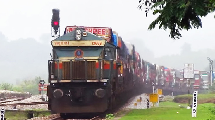 Trucks Lining Up To Take The Train | Train Fanatics Videos